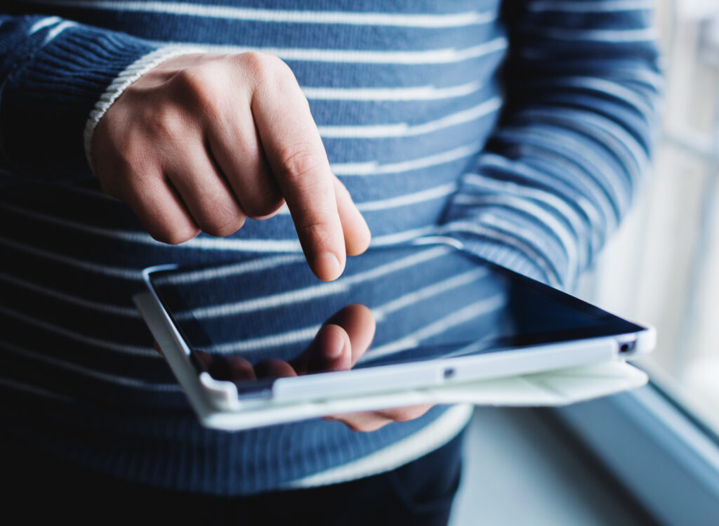 The,Man,Uses,A,Tablet,Pc.,Modern,Gadget,In,Hand.